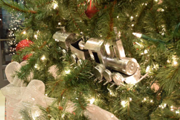An image of a Christmas tree with train ornaments