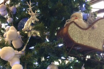 A closeup image of ornaments on a Christmas tree