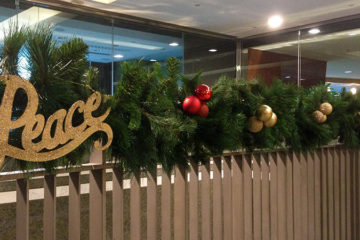 An image of garland and ornaments placed along a guard rail