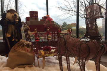 An image of a Christmas tree, deer, and a sleigh